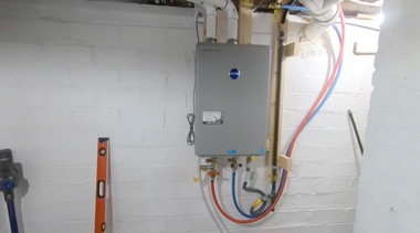 add a tankless water heater to existing system