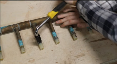 a plumber using a proprietary tool